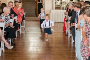 ring bearers walking down aisle at wedding ceremony