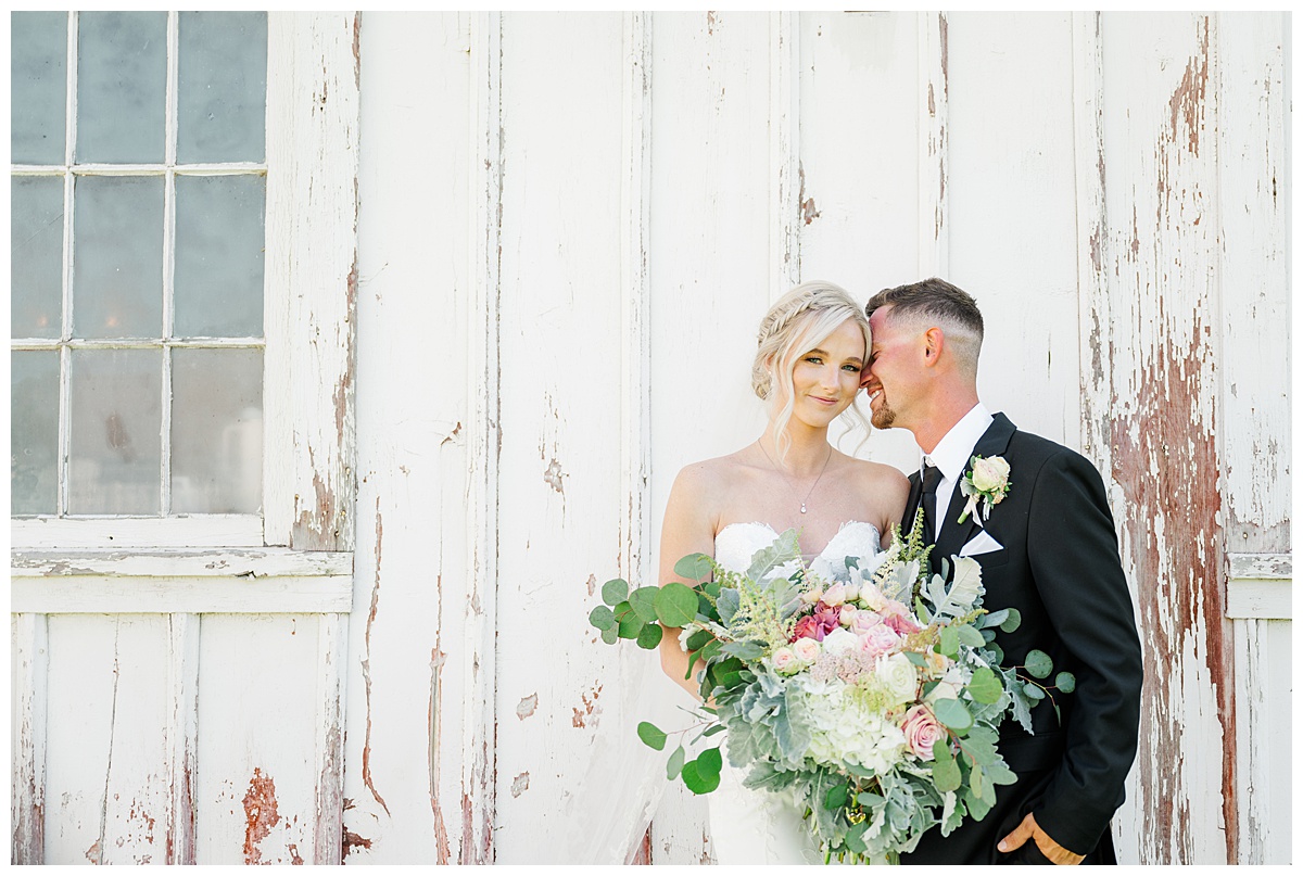 bride and groom portraits at the white barn