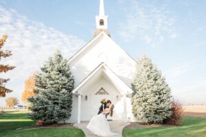 bride and groom portraits at still water hollow wedding in front of chapel